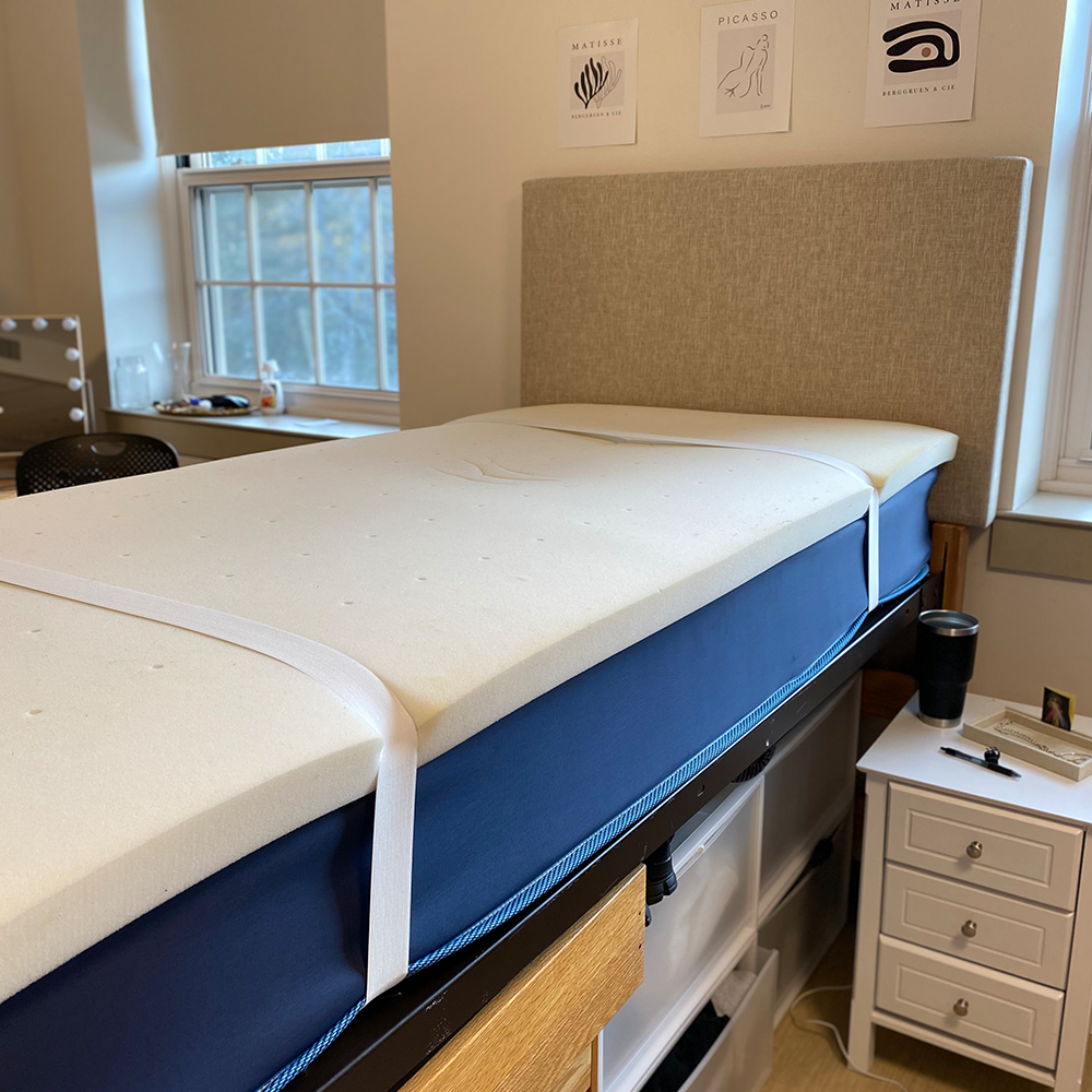 Bedly Straps installed on a college dorm Twin XL bed with the mattress topper and fitted sheet secured